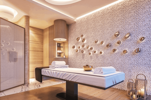 A massage table in a spa room with white walls.
